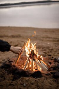 Putting sticks on a fire