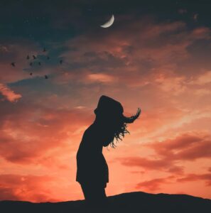 Woman at sunset with moon